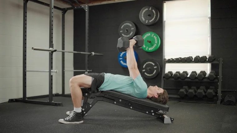 BarBend’s Jake Herod making use of a decline bench and dumbbells.